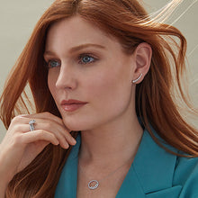将图片加载到图库查看器,women with long red hair blue eyes white skin, wearing silver cubic zirconia ear climber on sterling silver, lady also wearing halo cz pendant on uk sterling silver and silver diamond looking rings. Model is wearing turquoise blazer on beige background