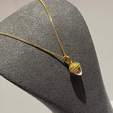 将图片加载到图库查看器,Yellow gold curb chain with a small solid acorn suspended. The acorn is gold and silver with much detail. This necklace is on a grey display bust on white background