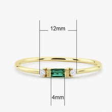 Load image into Gallery viewer, Emerald cut cubic zirconia on Yellow gold plated dainty ring. two clear diamond looking cubic zirconia sit either side , stacking rings  Edit alt text
