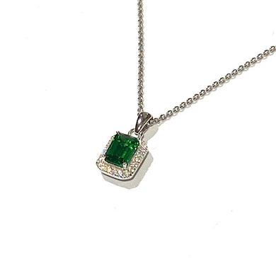 Square Emerald Cut Simulated Emerald Gemstone surrounded by a halo of diamonds on a silver curb chain on white background