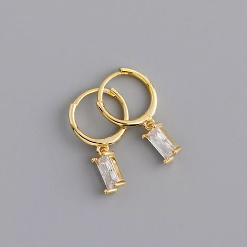 mini gold on silver huggie hoops with rectangular cubic zirconia claw set stone drop handing from the circular hoop pictured on grey background