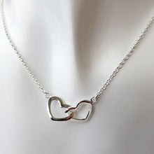 Cargar imagen en el visor de la galería, a duo of two 925 silver hearts interlinked with each other , plain hearts suspended on dainty silver chain on white background
