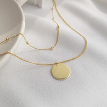 Cargar imagen en el visor de la galería, Coin or disc pendant on double layered chain, one chain has a beads dotted all along the one chain. The other had the round disc pendant sitting on it.  18ct gold plated chains.
