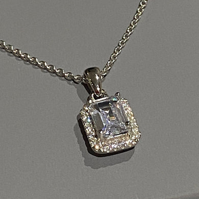 stunning silver and white gold square claw set imitation diamond on plain silver bale. The centre stone is surrounded by a halo of little diamonds, image on grey background